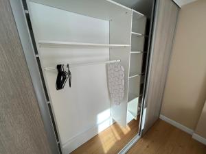 a white closet with a glass door at Le Chalet - maison avec jardin et parking in Lourdes +35 photos