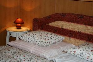 a bedroom with two beds and a lamp on a table at Zderaz in Prague