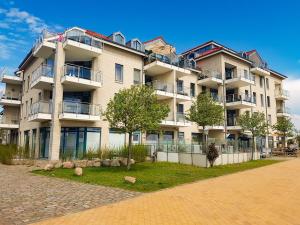 a large apartment building with balconies and trees at Strandburg-Küken in Fehmarn