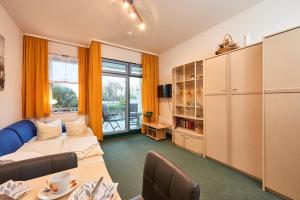 a living room with a couch and a table at Strandburg-Küken in Fehmarn