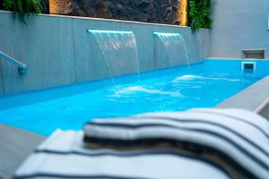 a swimming pool with a water fountain in the middle at H Ocaranza in Santiago +82 photos