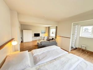 a bedroom with two beds and a living room at Pier 7 im Pierspeicher in Kappeln