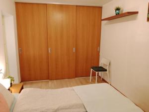 a bedroom with a closet and a bed and a chair at City center Raua apartment with balcony in Tallinn
