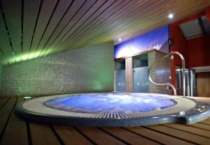 a bathroom with a large tub in a room at Hotel Sancho Abarca Petit SPA in Huesca