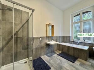 a bathroom with a shower and a sink and a tub at Villa EMG Düsseldorf Essen Dortmund - Velbert in Velbert