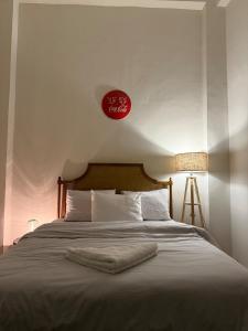 a bedroom with a bed with a clock on the wall at Luxury apartment with private balcony 1007 in Cairo