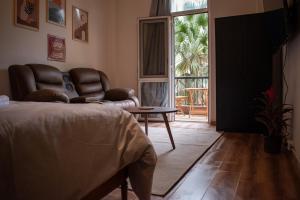 a living room with a bed and a chair and a table at Luxury apartment with private balcony 1007 in Cairo