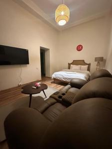 a living room with a couch and a bed at Luxury apartment with private balcony 1007 in Cairo