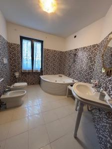 a bathroom with a tub and a toilet and a sink at B&B Il Papavero in Tuscania +44 photos