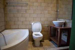 a bathroom with a toilet and a tub and a sink at Luxury apartment with private balcony 1007 in Cairo +17 photos