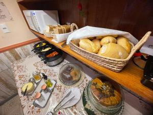 a table with baskets of bread and other foods on it at Refúgio Pousada Fortaleza in Fortaleza