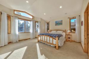 a bedroom with a bed and some windows at Das Waldhaus 1973P in South Lake Tahoe