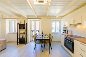 a kitchen with a table and chairs in a room at Helena Old Town Corfu 3 in Corfu