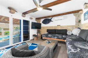 a living room with a couch and a tv at Villa Lea Lana Vinodol by aneo travel in Novi Vinodolski