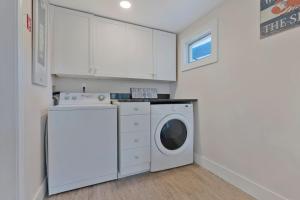 a laundry room with a washing machine and a washer at Renovated Coastal Haven Camp Ellis Classic Escape in Saco