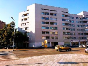 a yellow car parked in a parking lot in front of a building at City center Raua apartment with balcony in Tallinn
