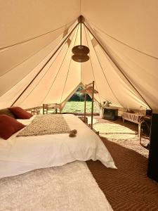 a bedroom with a tent with a bed in it at Tribu Lodge in São Bartolomeu de Messines