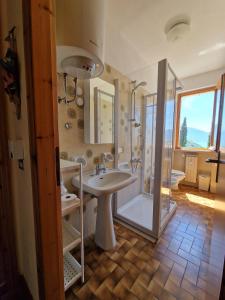 a bathroom with a sink and a shower and a sink at LA PERLA DEL CENTRO LAGO DI COMO in Perledo