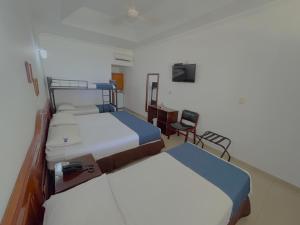 Postel nebo postele na pokoji v ubytování Hotel Los Puentes Comfacundi