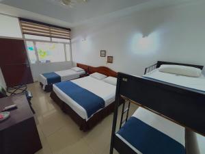 Postel nebo postele na pokoji v ubytování Hotel Los Puentes Comfacundi
