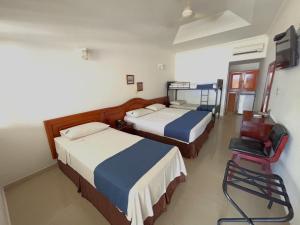 Postel nebo postele na pokoji v ubytování Hotel Los Puentes Comfacundi