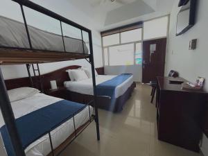 Postel nebo postele na pokoji v ubytování Hotel Los Puentes Comfacundi