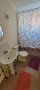 a bathroom with a white sink and a toilet at Casa Fundadores in Puerto Montt +9 photos