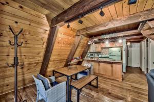 a dining room and kitchen in a cabin with wooden walls at 3001R Reindeer A Frame Cabin in South Lake Tahoe +19 photos