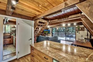 a kitchen with a counter and a living room at 3001R Reindeer A Frame Cabin in South Lake Tahoe