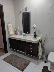 a bathroom with a sink and a mirror at Chácara Morada do Sol in Sepetiba