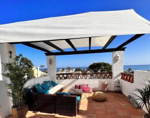 a large white canopy on a patio with the ocean at Casa Carmen in Marbella