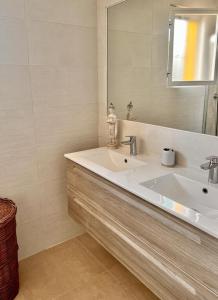 a white bathroom with a sink and a mirror at Casa Carmen in Marbella