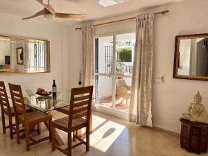 a dining room with a glass table and chairs at Casa Carmen in Marbella