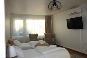 a hotel room with two beds and a flat screen tv at BlueSolarPearl T - More than a hotel in Nokia