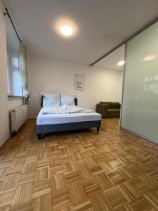 a bedroom with a bed and a large screen at Study & Work am Campus Chemnitz in Chemnitz