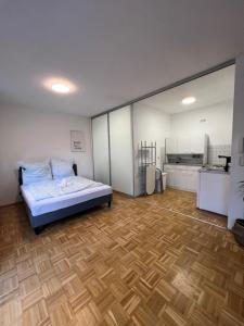 a bedroom with a bed and a wooden floor at Study & Work am Campus Chemnitz in Chemnitz +9 photos