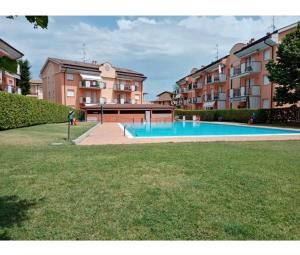 a swimming pool in front of some apartment buildings at Angelica apartment in Sirmione