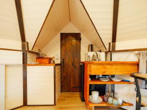 an attic kitchen with a wooden counter and a door at Sunset Retreats The Shire in Ombersley