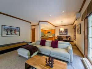 a living room with a couch and a table at Stunning 3bdr with Private Sauna - Plateau 202-5 in Mont-Tremblant