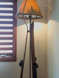 a lamp with a christmas tree on it next to a window at Stunning 3bdr with Private Sauna - Plateau 202-5 in Mont-Tremblant