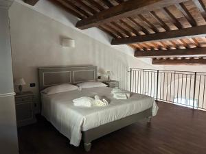 a bedroom with a bed with white sheets and pillows at Palazzo Contelori in Terni