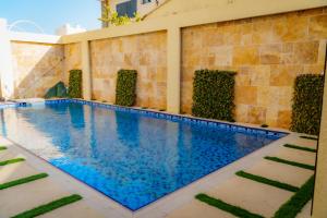 a swimming pool with blue water in a building at The Villa Haramous in Djibouti