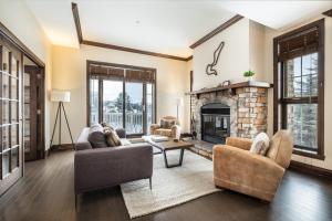 a living room with two couches and a fireplace at Luxury 3 bdr on the village - Bondurant 95-15 in Mont-Tremblant