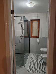 a bathroom with a shower and a toilet at Apartments Bosana XIV in Biograd na Moru +47 photos