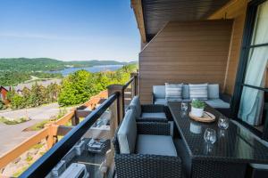 a balcony with a table and chairs and a view at Luxury Living on the Slopes - Horizon 2-204 in Mont-Tremblant