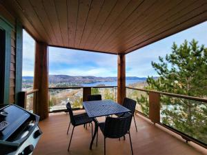 a patio with a table and chairs on a balcony at Luxury Meets Adventure - Equinoxe 170-8 in Mont-Tremblant