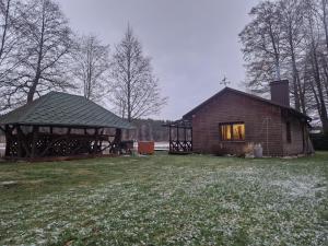 a log cabin with a window and a gazebo at Glamping Druskininkai in Grūtas +10 photos
