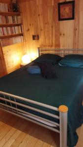 a bedroom with a bed in a wooden room at Maison bois vue Causse Larzac et viaduc in Millau +30 photos