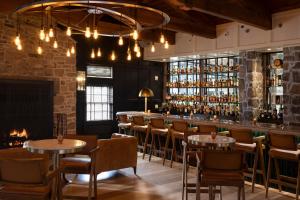 a bar with tables and chairs and a fireplace at Logan Inn in New Hope