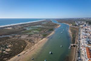 an aerial view of a beach with boats in the water at Bright & Cozy House with Terrace by HostWise in Conceição